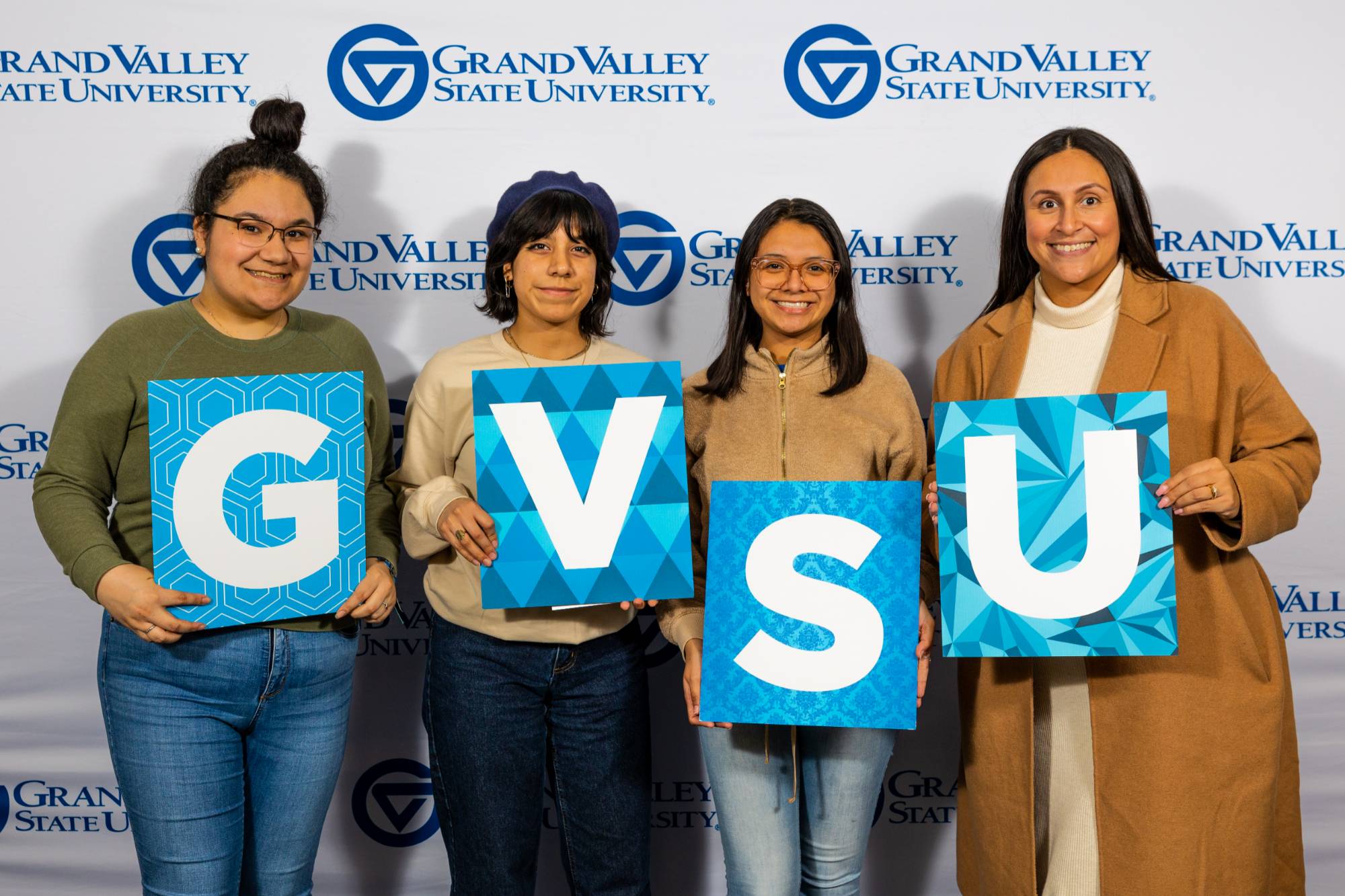 Students holding GVSU letters